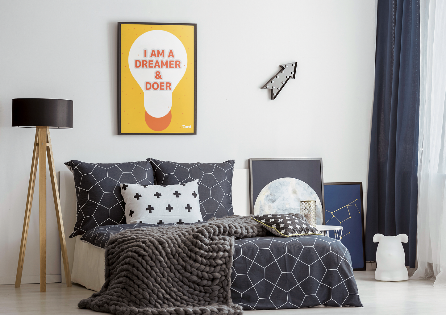 Wall art saying i am a dreamer and doer against a Modern bedroom with geometric bedding, decorative pillows.